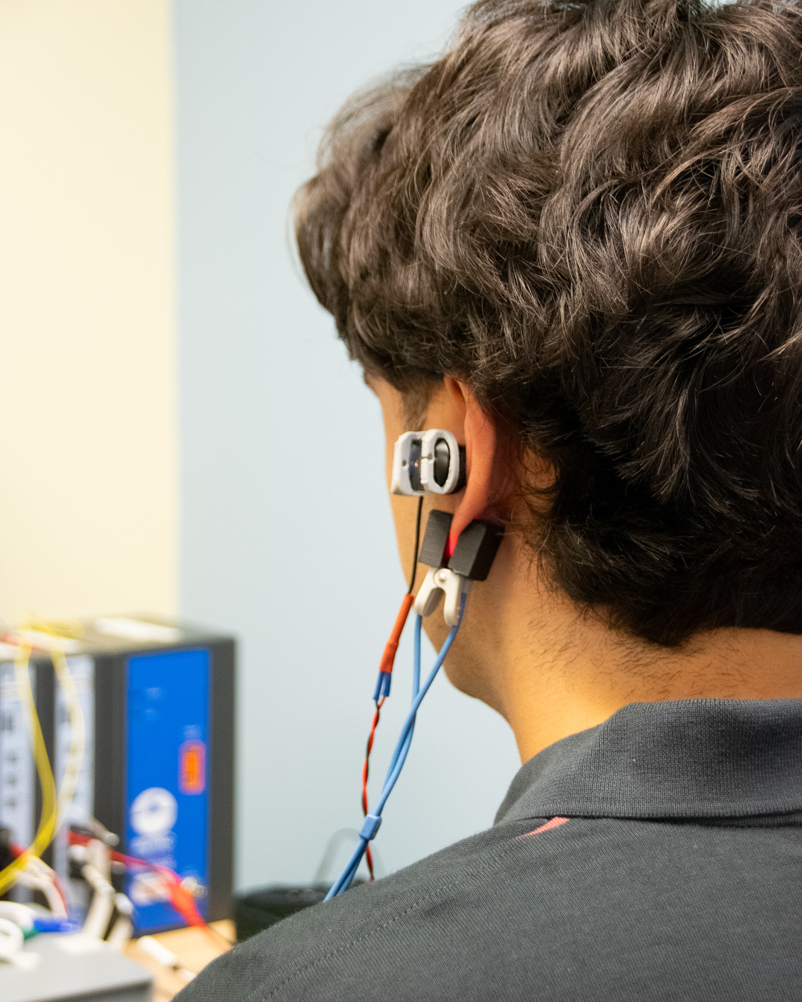 Photo of person wearing the ear bud technology